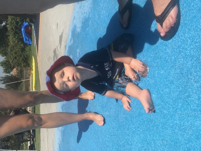 A todler playing in a little fountain