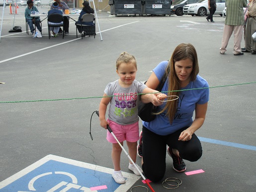 A blind child enjoying the ring toss