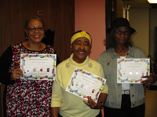 Here are three adults holding certificates showing that they had indeed accomplished all of the tasks for Sensory Day at BSS.