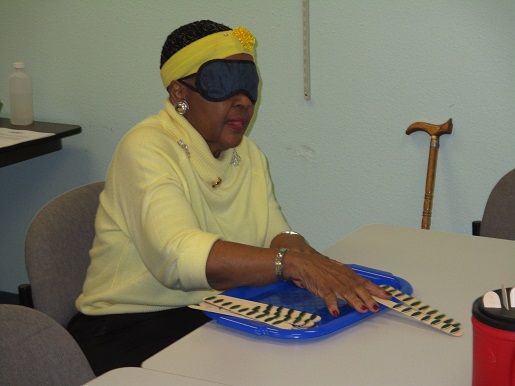 Another woman is trying to do the tasks at the sensory day event.
