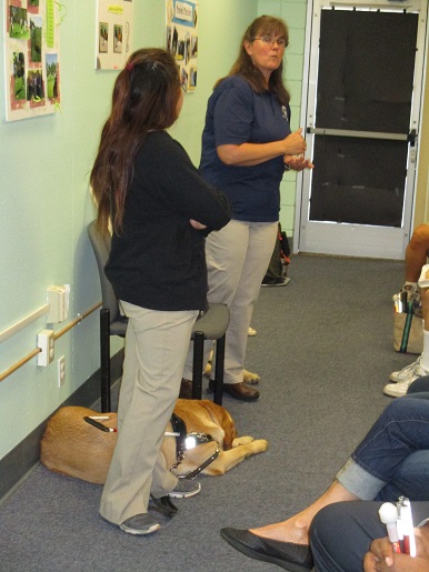 Two trainers for the Guide Dogs of America are giving a presentation on service dogs