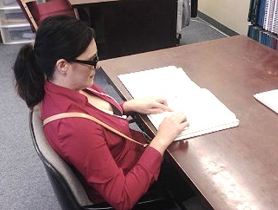 Octavia reading Braille with her fingers