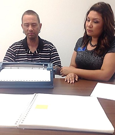 Timothy is learning how to type Braille.