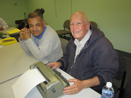 Ramiro is learning how to type Braille with Ciro Trulillo.