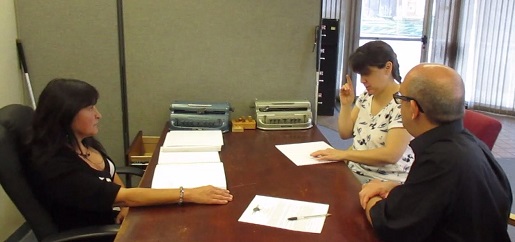 Christine is teaching Anna Marie how to read Braille.