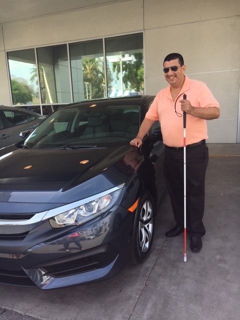 Pete Benavidez standing with a new car purchased by Title 7 for the Department of Older Adults