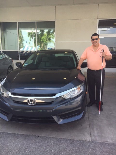 Pete Benavidez standing with a new car purchased by Title 7 for the Department of Older Adults
