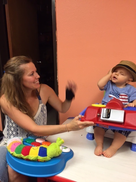 The smile and laughter he shows indicates that this toy meets with his approval