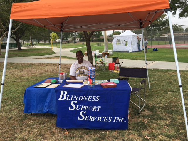 Sitting under a tarp at the Park Day Event