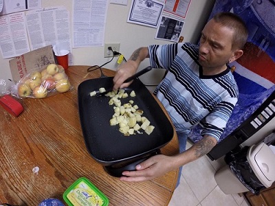 Timothy is learning how to cook food for himself.