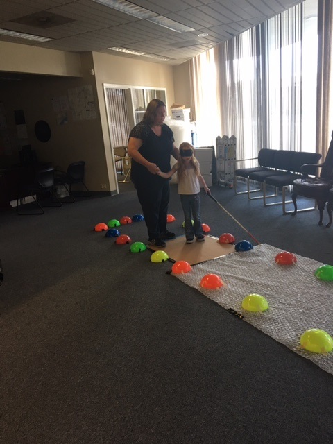 A child and her parent are navigating one of the mazes