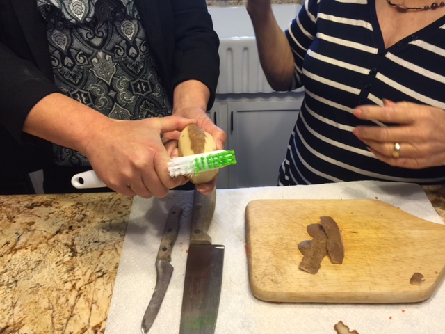 A senior is learning how to prepare vegitables.