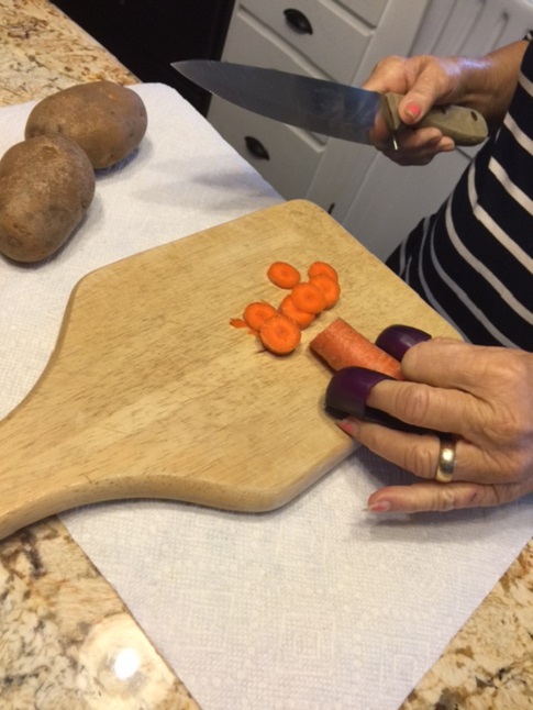 Using finger gaurds to protect yourself when chopping vegitables.