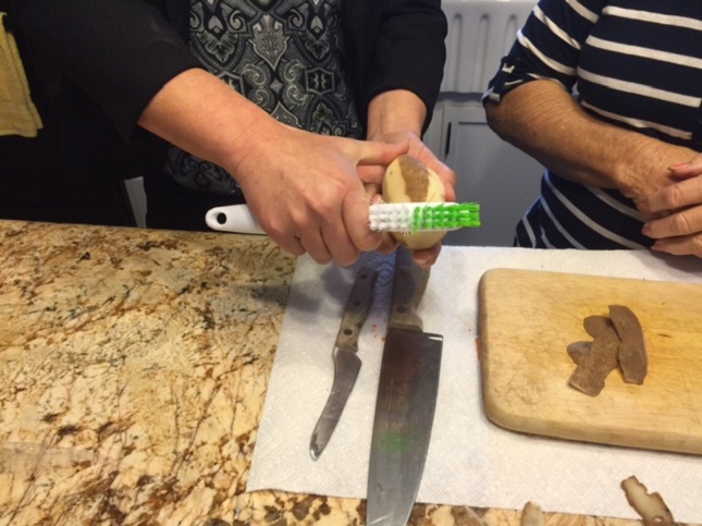 A senior is learning how to prepare vegitables.