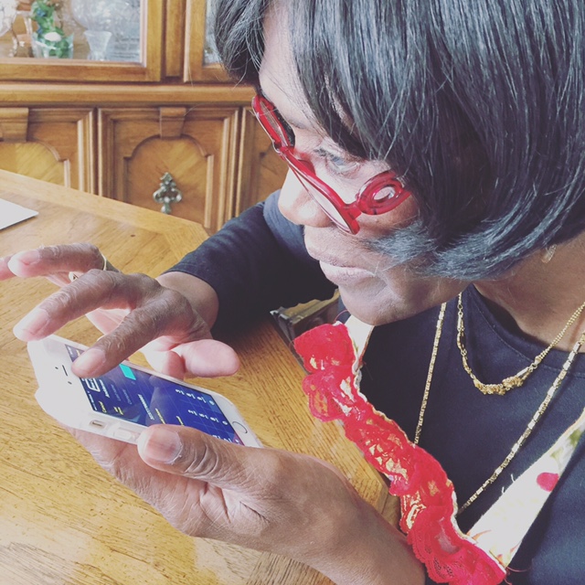 Gertrude using an iPhone.