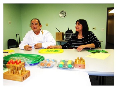 Manny and Christine learning large print Braille.