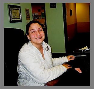 Dani Ridgman sitting at the front desk