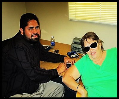 Luis giving Assistive Technology instruction to Teresa Carter-Mealer