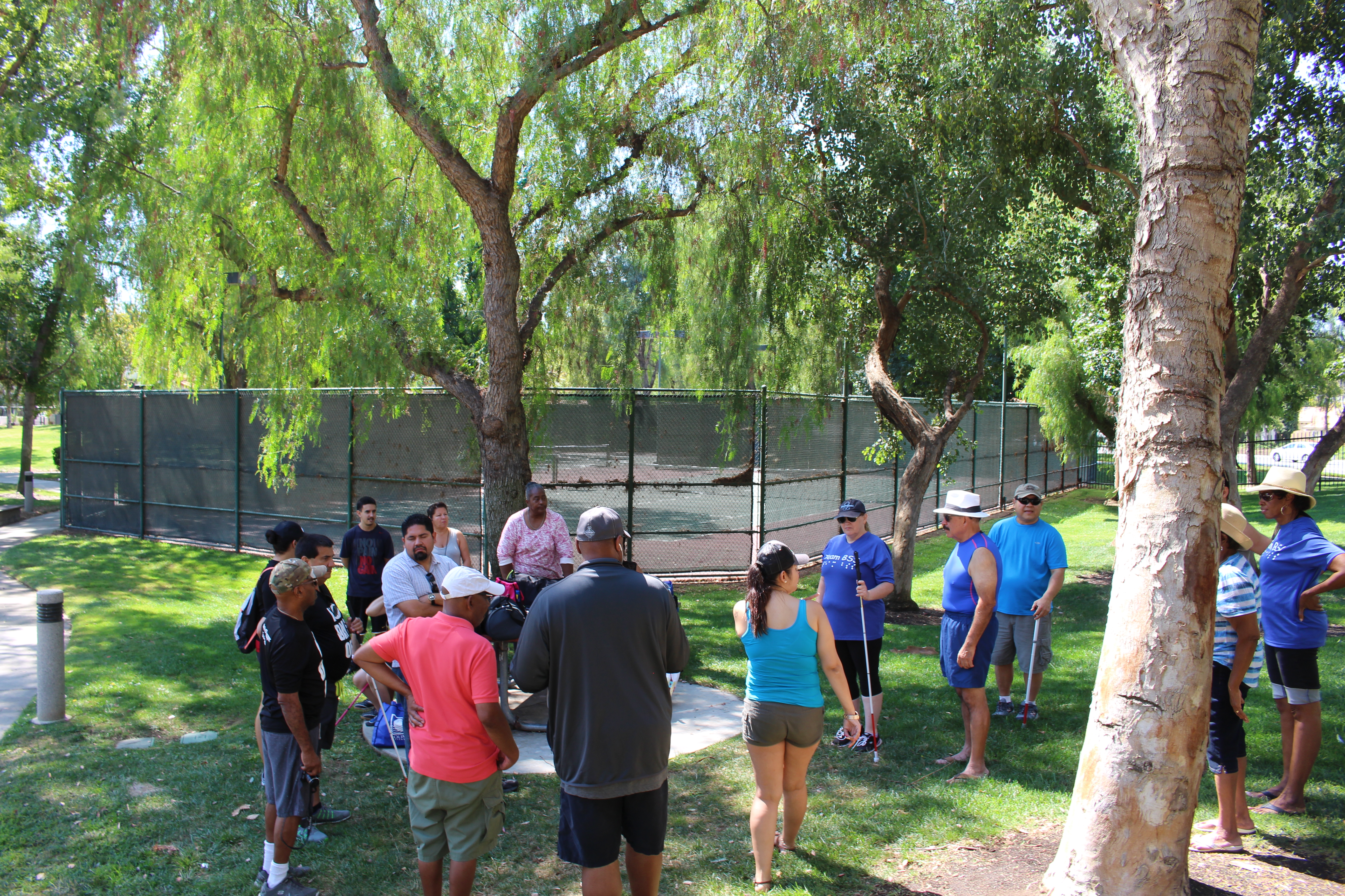 Those in attendance meet up on the lawn by some tennis and basketball courts