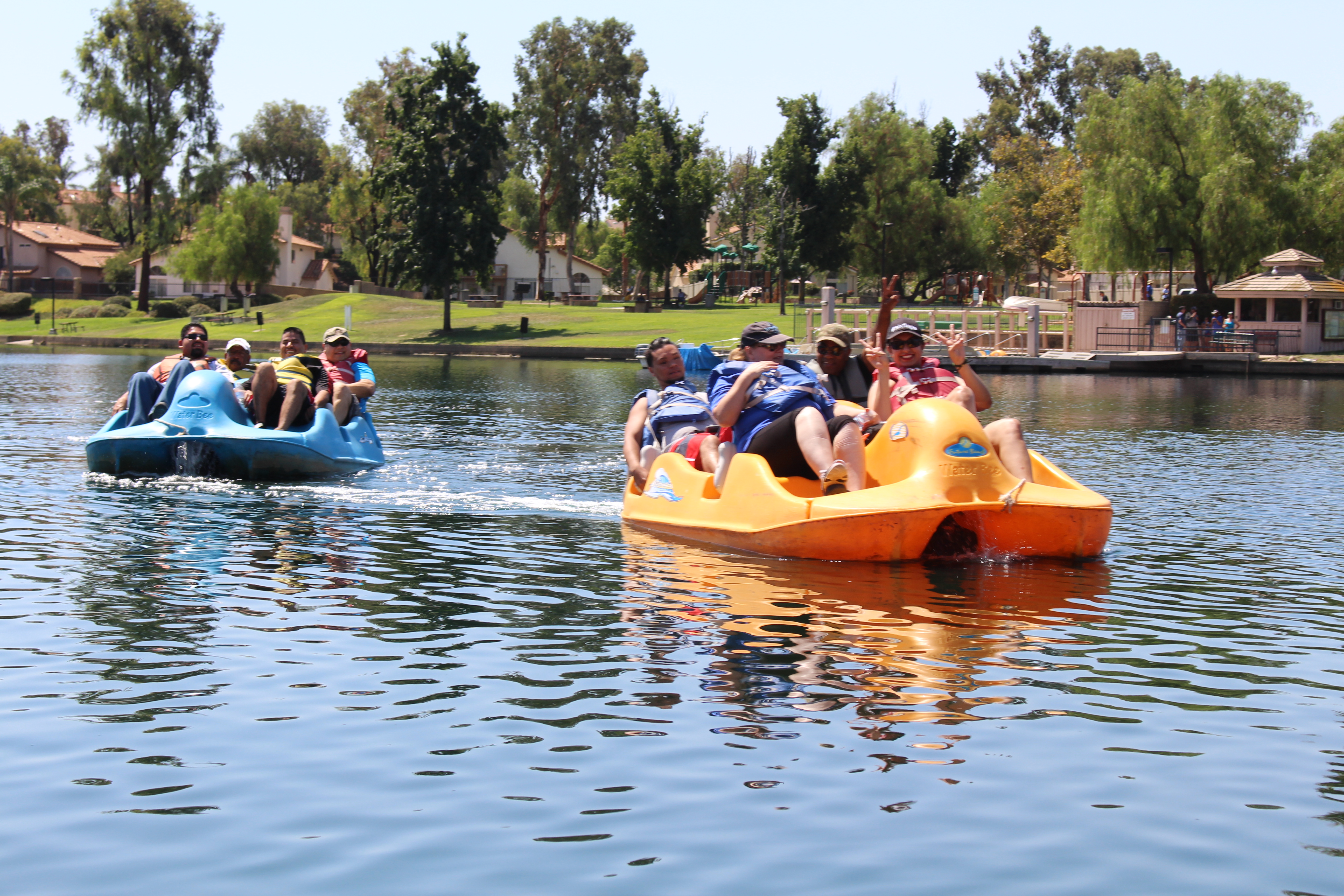 Two groups driving paddle boats on the lake